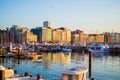 Gijon, Asturias, Spain; 09/26/2018: Sunset in the dock of Gijon, Asturias, Spain. Reflections of the boats in the water