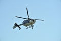 Gijon, Spain - July 24, 2022. Botton view of Policia Nacional Spanish Police Eurocopter EC135 in flight during Gijon