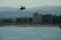 Gijon, Spain - July 24, 2022. Policia Nacional Spanish Police Eurocopter EC135 flying over San Lorenzo Beach during Gijon