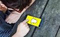 top view of woman using smartphone over wooden table with snapchat on screen