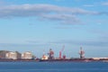 Coal cargo ship moored in port with lifting cargo cranes, ships and grain