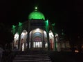 Gilan, Iran - summer, 2018: The shrine of Imam Zadeh Hashem outside the city of Gilan, green light dome in the dark of the night Royalty Free Stock Photo