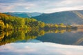 gilau lake of cluj country in evening light. beautiful landscape of romania in autumn. reflection on the calm water surface Royalty Free Stock Photo