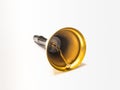 Gilded bell with a handle made of black plastic isolated on a white background