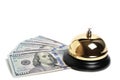 Gilded bell hotel service and hundred dollar bills white background.Conceptual hotel, travel and recreation