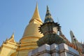 Gilded Buddhist temple of conical shape. Spiers of Asian religious buildings