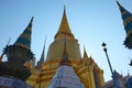 Gilded Buddhist temple of conical shape. Spiers of Asian religious buildings