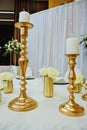 Gilded candlestick on a festive wedding table. Elegance wedding decor