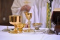 gilded chalices and bowls during a service on the altar Royalty Free Stock Photo