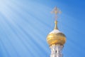 Gilded dome of a Christian temple illuminated by rays of sun Royalty Free Stock Photo