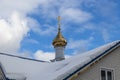 Gilded dome with a cross on a blue sky background Royalty Free Stock Photo