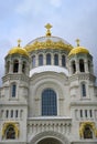 Gilded dome and crosses of St. Nicholas Cathedral with bell towers in Kronstadt, Russia, built in 1913