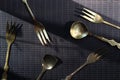 Gilded forks and spoons on a dark background Royalty Free Stock Photo