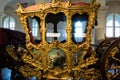 Gilded ornate historical carriage in a museum