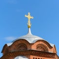 Gilded Orthodox Christian cross on the dome of the church against the blue sky Royalty Free Stock Photo