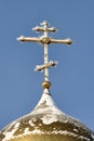 Gilded Russian Orthodox Cross on the Church Cupola in the Snow Royalty Free Stock Photo