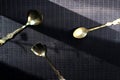 Gilded spoons on a dark background Royalty Free Stock Photo