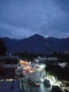 Gilgit, Pakistan. 23-10-23, Evening time of Danyore city chowk , traffic on the road.Mountains Black in background