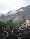 Gilgit, Pakistan : 28-August-2023, Chehlum Julus of Imam Hussain in Hunza valley. Mob of people. Mountains in background