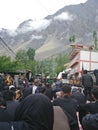 Gilgit, Pakistan : 28-8-2023, Chehlum Julus of Imam Hussain in Hunza valley. Mob of people. Mountains in background