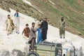 Pakistani People Collect Snow and load to the car in Mountains