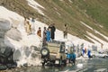 Pakistani People Collect Snow and load to the car in Mountains