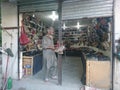 Gilgit, Pakistan, 14-11-2023, An old man looking for shoes in shop.