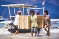 People unloading of the goods from speed wooden boat to Gili AIr, paradise island in Indonesia