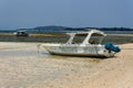 A wooden boat on a small beach on the tropical tourist island of Gili Air off the coast of Royalty Free Stock Photo