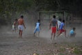 GILI ASAHAN, INDONESIA - AUGUST, 22 2016 - boys are playing soccer at sunset on a palm tree field near the beach