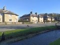 Gilling East village with stream and pheasant crossing the road North Yorkshire UK