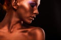 Gilt. Golden Woman's Face Closeup. Futuristic Gilded Make-up. Painted Skin bronze.