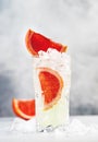 Gin bitter lemon trendy alcoholic cocktail drink with dry gin, tonic, grapefruit and ice cubes. Gray background with copy space Royalty Free Stock Photo