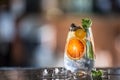 Gin tonic cocktailwith fresh tropical fruit on bar counter in pup or restaurant