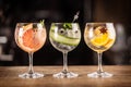 Gin tonic long drink as a classic cocktail in various forms with garnish in individual glasses such as orange, grapefruit, or