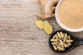 ginger powder with medicine capsules pills on wood table.