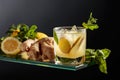 Ginger ale beer cocktail with lemon and mint in a frozen glass on a black background Royalty Free Stock Photo