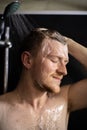 Ginger bearded naked man washing his hair taking shower with shampoo foam