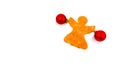 Ginger biscuit in the form of an angel with red balls on the sides isolated on white background. Royalty Free Stock Photo
