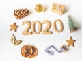 Ginger biscuits of the form of numbers and 2020 new year ginger cookies and xmas decoration frame on white background. Top view. Royalty Free Stock Photo