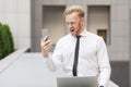 Ginger businessman shout in smart phone on video chat. Royalty Free Stock Photo