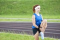 Ginger Caucasian Female in Athletic Sportgear Having Legs Stretching Exercises Outdoors Royalty Free Stock Photo