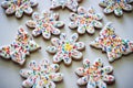 Ginger cookies decorated with white icing anf colorful sprinkles