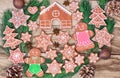 Ginger cookies. Gingerbread house, gingerbread man, stars and fir-tree on wooden background. Royalty Free Stock Photo