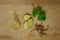 Ginger and coriander spices on wooden trencher