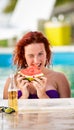 Ginger curly girl on piscine refreshing with watermelon Royalty Free Stock Photo