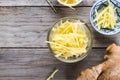 Ginger cut into strips on wooden table Royalty Free Stock Photo