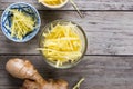 Ginger cut into strips on wooden table Royalty Free Stock Photo