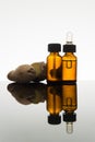 Ginger essential oil in amber bottle with ginger root and dropper