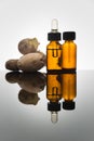 Ginger essential oil in amber bottle with ginger root and dropper